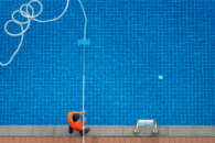 man cleaning swimming pool